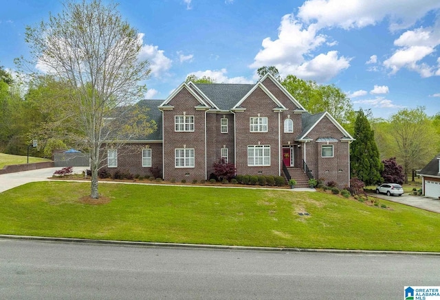 view of front of house with a front lawn and brick siding