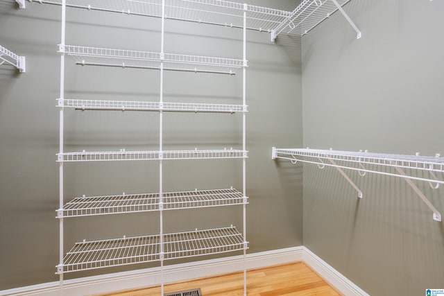 walk in closet featuring wood finished floors