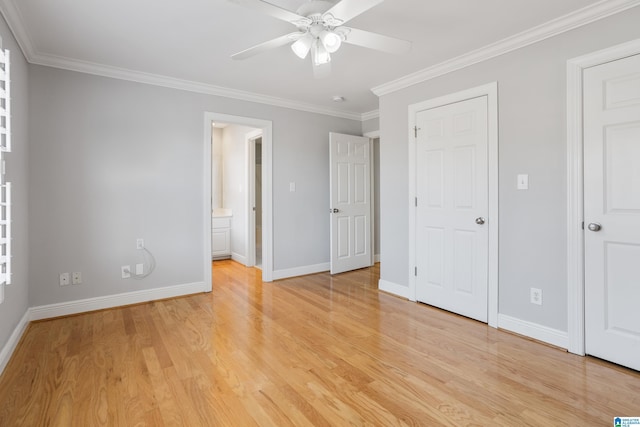 unfurnished bedroom featuring crown molding, baseboards, and light wood-style floors