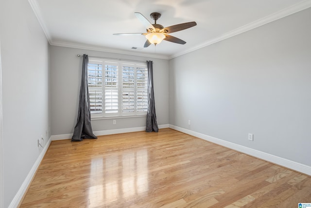 spare room featuring visible vents, baseboards, light wood-style flooring, ceiling fan, and ornamental molding