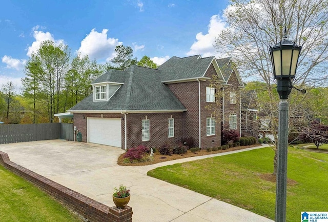 view of front of home featuring brick siding, fence, a garage, driveway, and a front lawn