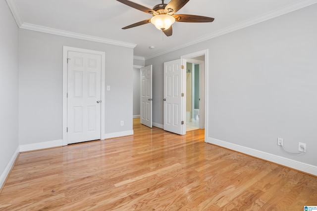 unfurnished bedroom featuring ornamental molding, baseboards, and wood finished floors