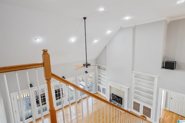 living room with built in features, ceiling fan, wood finished floors, a fireplace, and recessed lighting