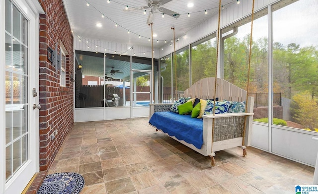 sunroom / solarium with rail lighting and ceiling fan