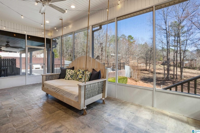 sunroom / solarium featuring ceiling fan