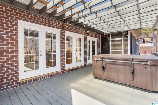 wooden terrace featuring french doors and an indoor hot tub