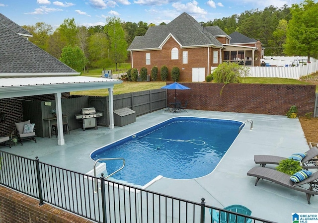 view of swimming pool with grilling area, a patio area, fence private yard, and a fenced in pool