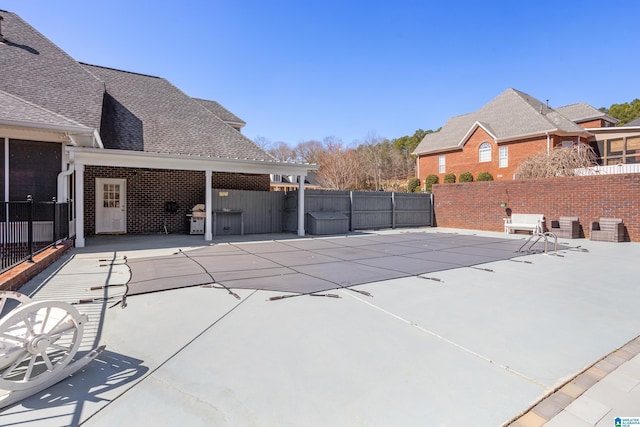 view of pool with a patio area, fence, and area for grilling