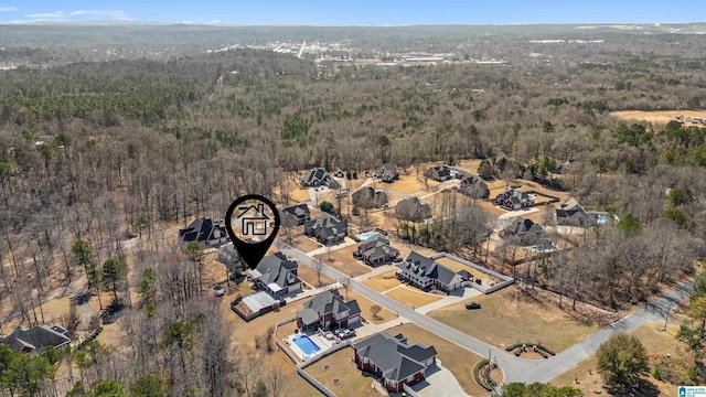 drone / aerial view featuring a wooded view