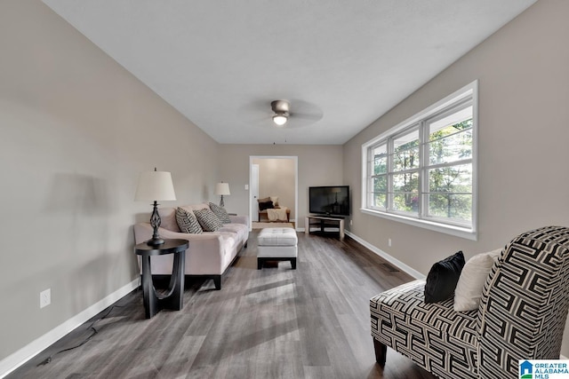 living room featuring hardwood / wood-style flooring and ceiling fan