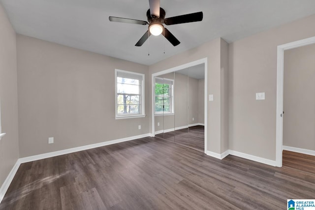 unfurnished room featuring ceiling fan and dark hardwood / wood-style floors