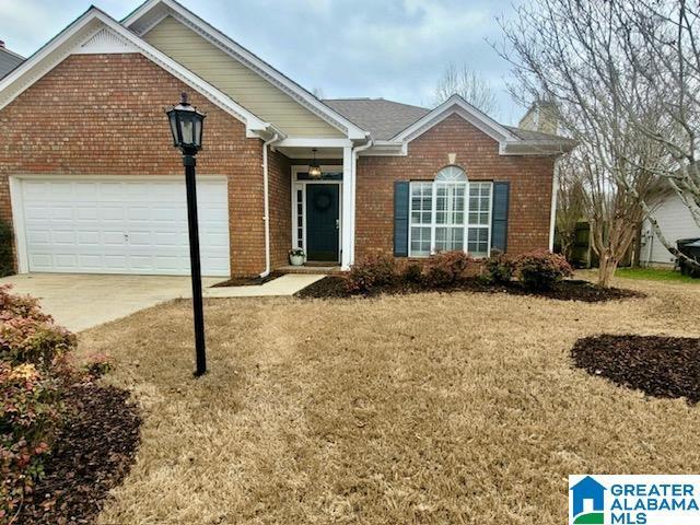 view of front of home with a front lawn and a garage