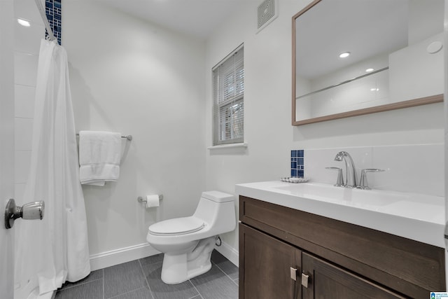 bathroom with vanity, toilet, tile patterned floors, and backsplash