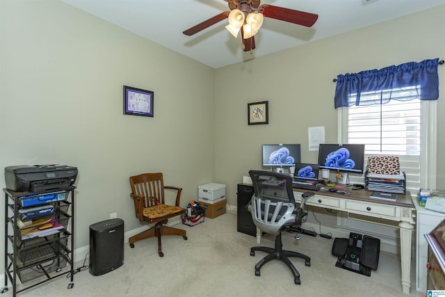 carpeted office space featuring ceiling fan