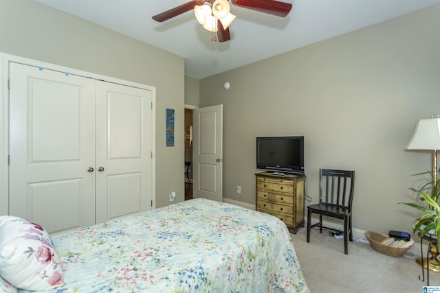 carpeted bedroom featuring a closet and ceiling fan