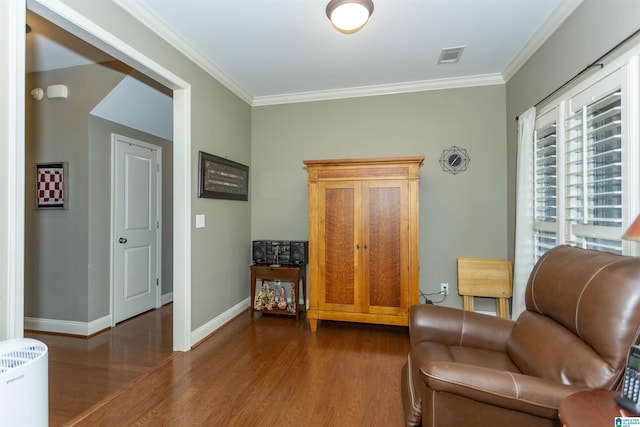 living area with ornamental molding and dark wood-type flooring