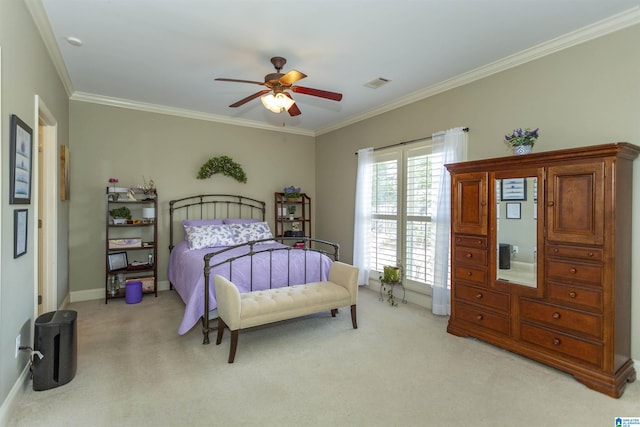 carpeted bedroom featuring crown molding and ceiling fan