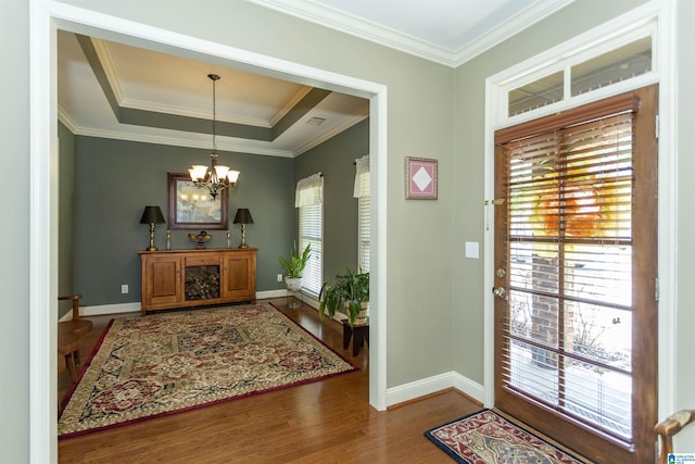 foyer entrance with an inviting chandelier, hardwood / wood-style flooring, and a wealth of natural light