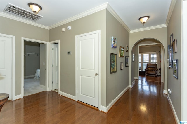 corridor featuring ornamental molding and dark hardwood / wood-style floors