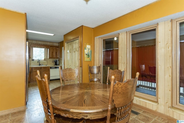 dining area with sink and a textured ceiling