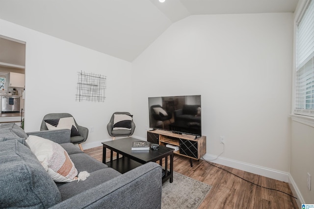 living room featuring hardwood / wood-style flooring and vaulted ceiling