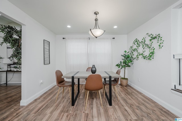 dining space with hardwood / wood-style floors