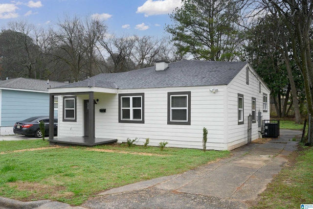 ranch-style house with central AC and a front yard