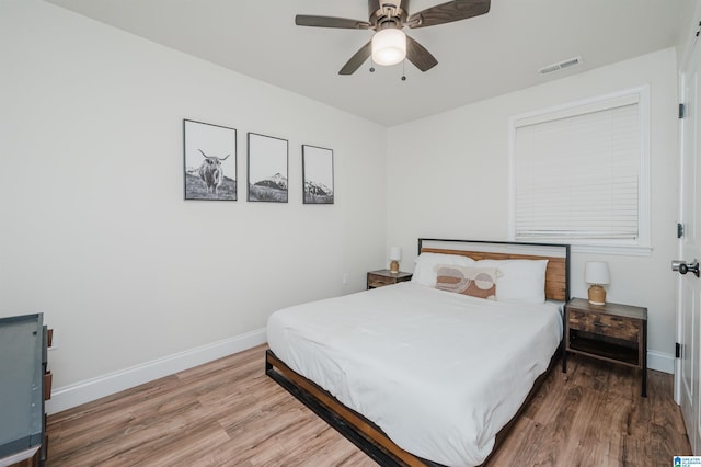 bedroom with hardwood / wood-style floors and ceiling fan