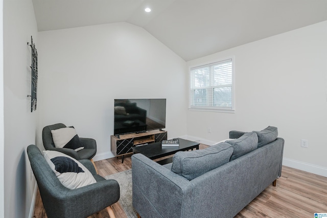 living room with lofted ceiling and light hardwood / wood-style flooring