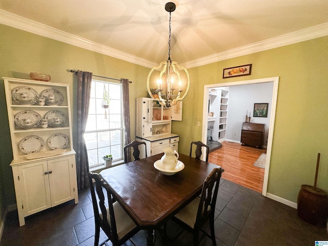 dining area featuring a notable chandelier, baseboards, and crown molding