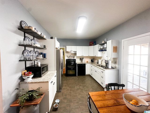 kitchen featuring light stone counters, open shelves, a sink, white cabinetry, and black appliances