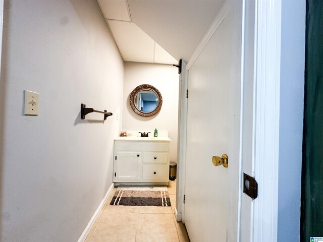 bathroom featuring vanity, baseboards, and tile patterned floors