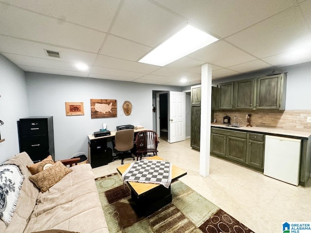 living area featuring light floors, visible vents, and a drop ceiling