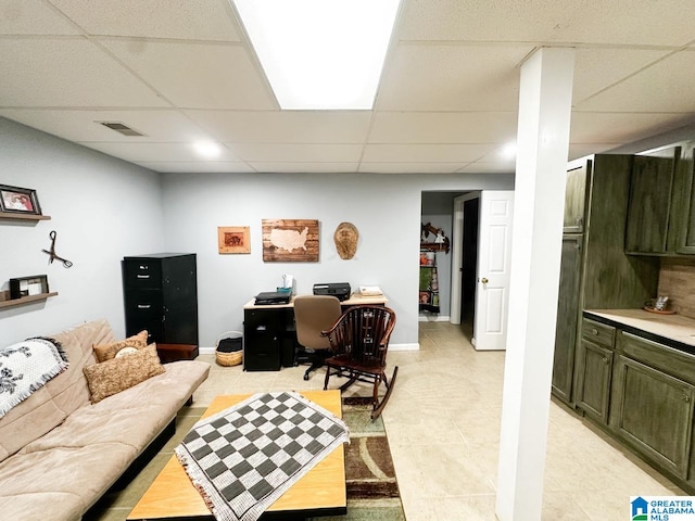 office area featuring a paneled ceiling, baseboards, and visible vents