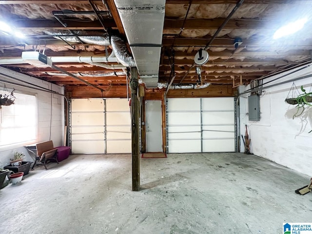 garage with a garage door opener and electric panel