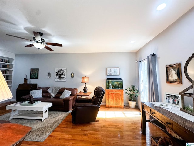 living area with a ceiling fan, wood finished floors, and recessed lighting