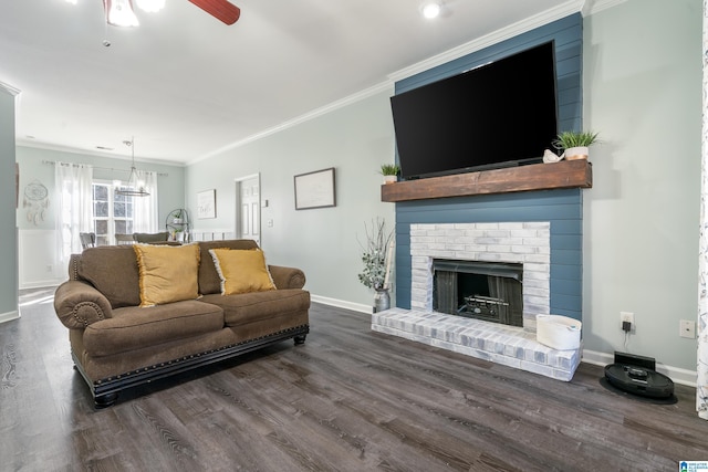 living area with a brick fireplace, dark wood-type flooring, and crown molding