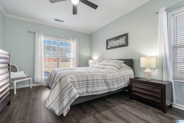 bedroom featuring dark wood-style flooring, visible vents, ornamental molding, ceiling fan, and baseboards