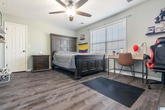 bedroom with dark wood-style flooring, visible vents, ceiling fan, and baseboards