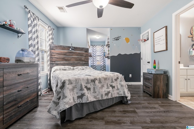 bedroom featuring dark wood-style flooring, connected bathroom, visible vents, and baseboards