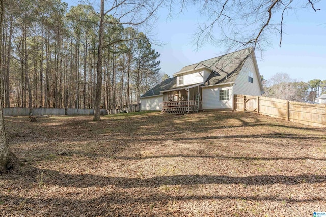 exterior space with a lawn, fence, and a wooden deck