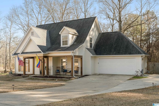 view of front of house with a porch, roof with shingles, driveway, and an attached garage