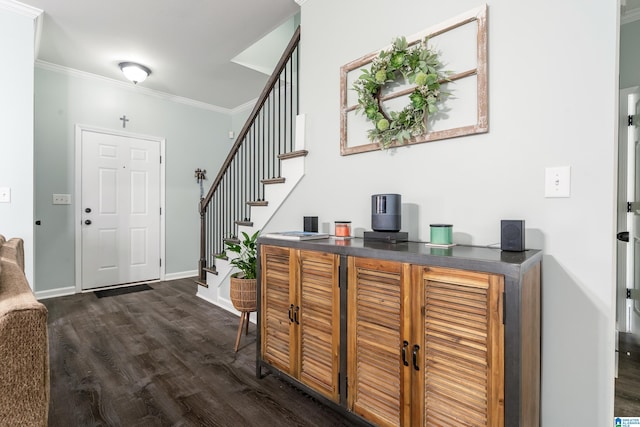 foyer featuring stairs, ornamental molding, dark wood-style flooring, and baseboards