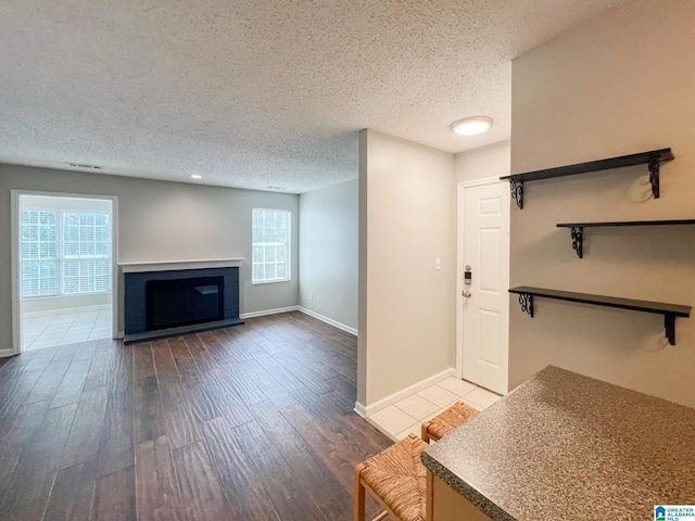 interior space with wood-type flooring and a textured ceiling