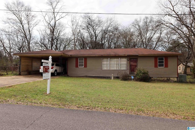 ranch-style home featuring a carport and a front yard