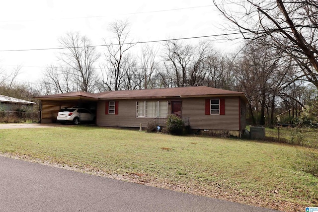 view of front facade with a front lawn and a carport