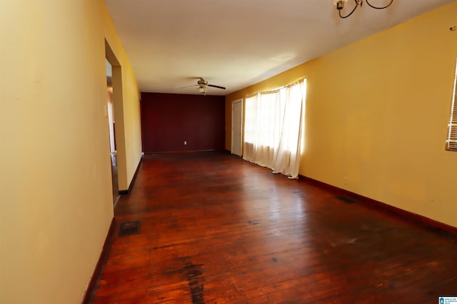 empty room featuring dark hardwood / wood-style flooring and ceiling fan