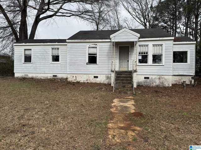 view of front of property with entry steps, a front lawn, and crawl space