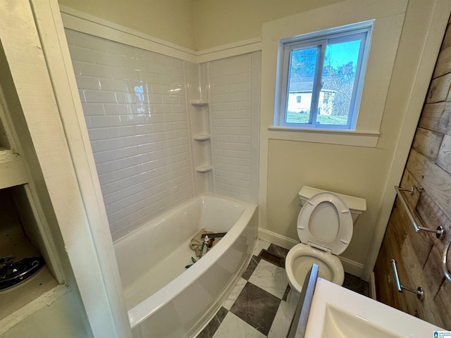 bathroom featuring tiled shower / bath and toilet