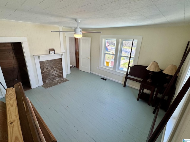 sitting room featuring wood-type flooring and ceiling fan